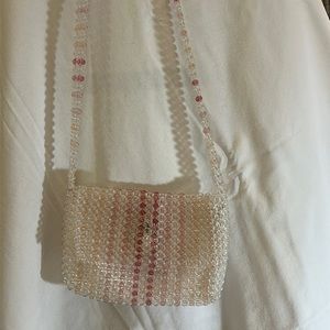 A beautiful simple pink beaded purse by the brand Issac Mizrahi New York.